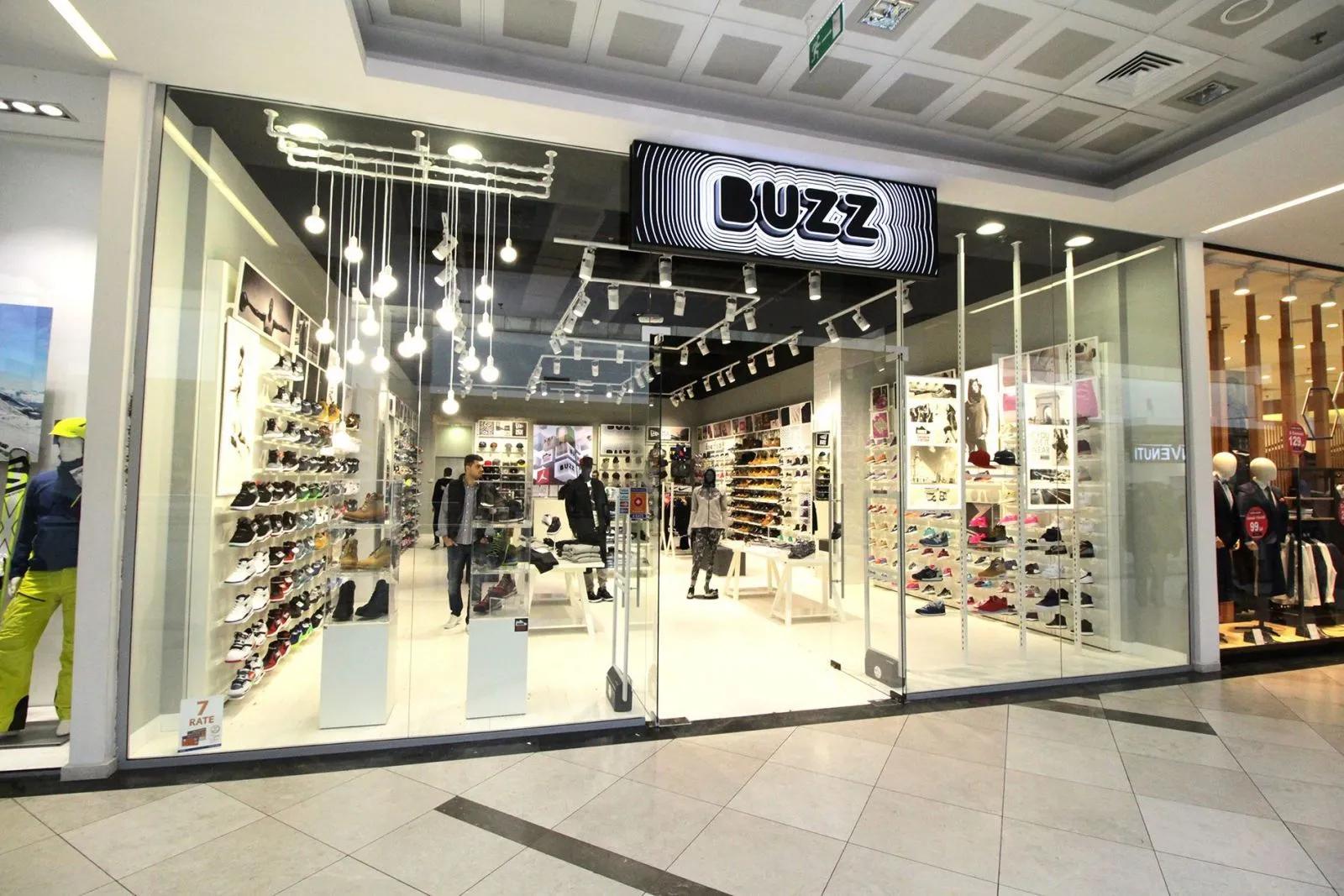 Buzz shoe store in a mall with shoes displayed in its windows.