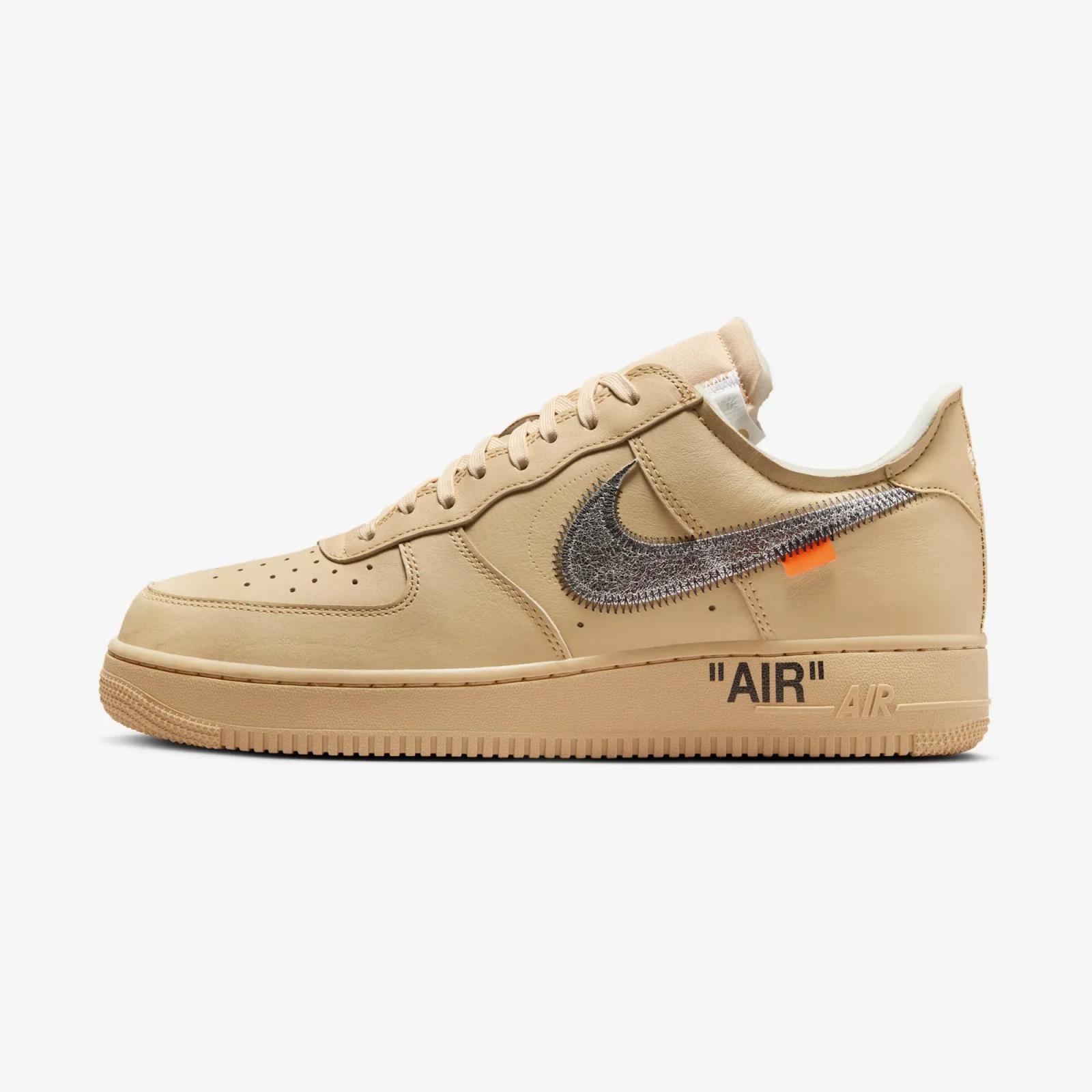 Tan Off-White Nike Air Force 1 Low sneaker with metallic silver swoosh, orange tab, and "AIR" text.