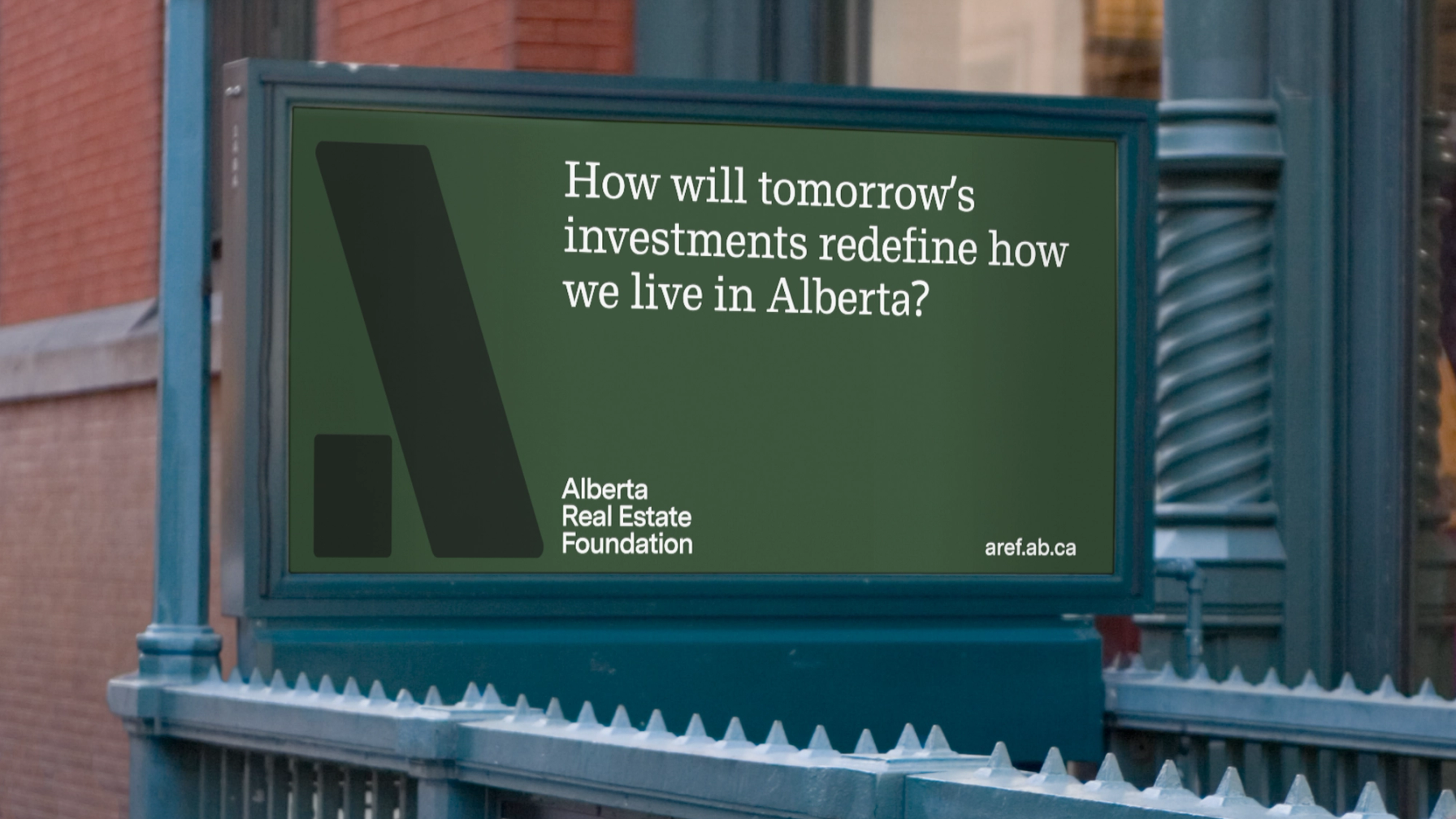 A billboard sign for AREF in green.