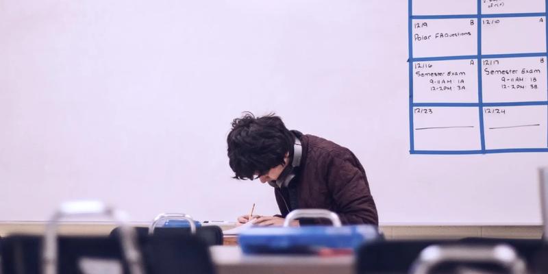 Student writing in classroom, representing NRI quota in India and its impact on education and admission eligibility.