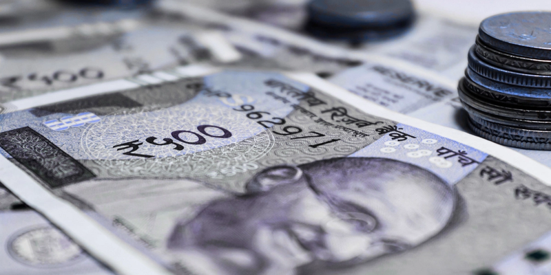 NRI reviewing compliance documents with FEMA penalty notice visible on screen