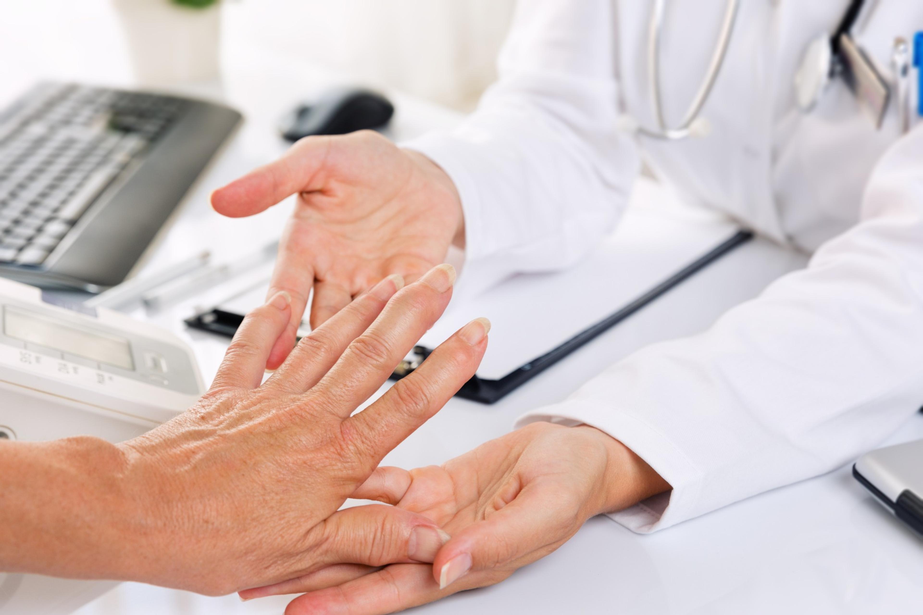 A doctor examining a patient's hand