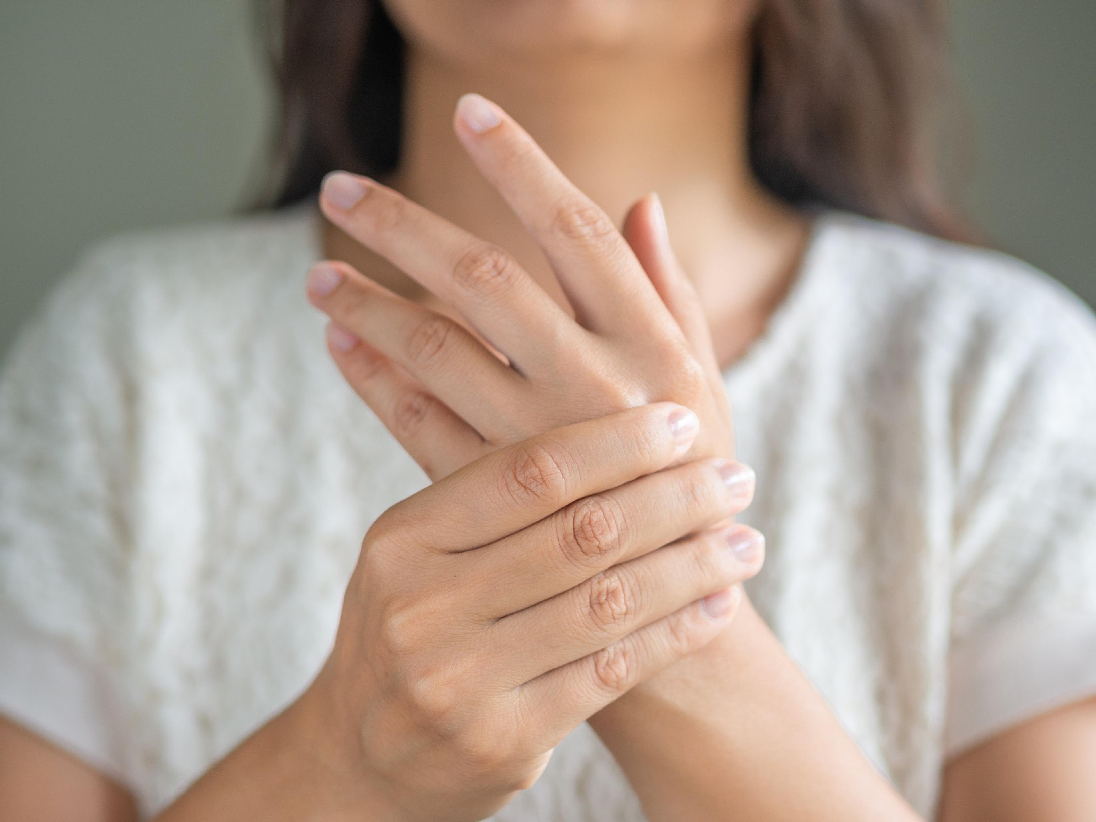 A woman holding her sore hand
