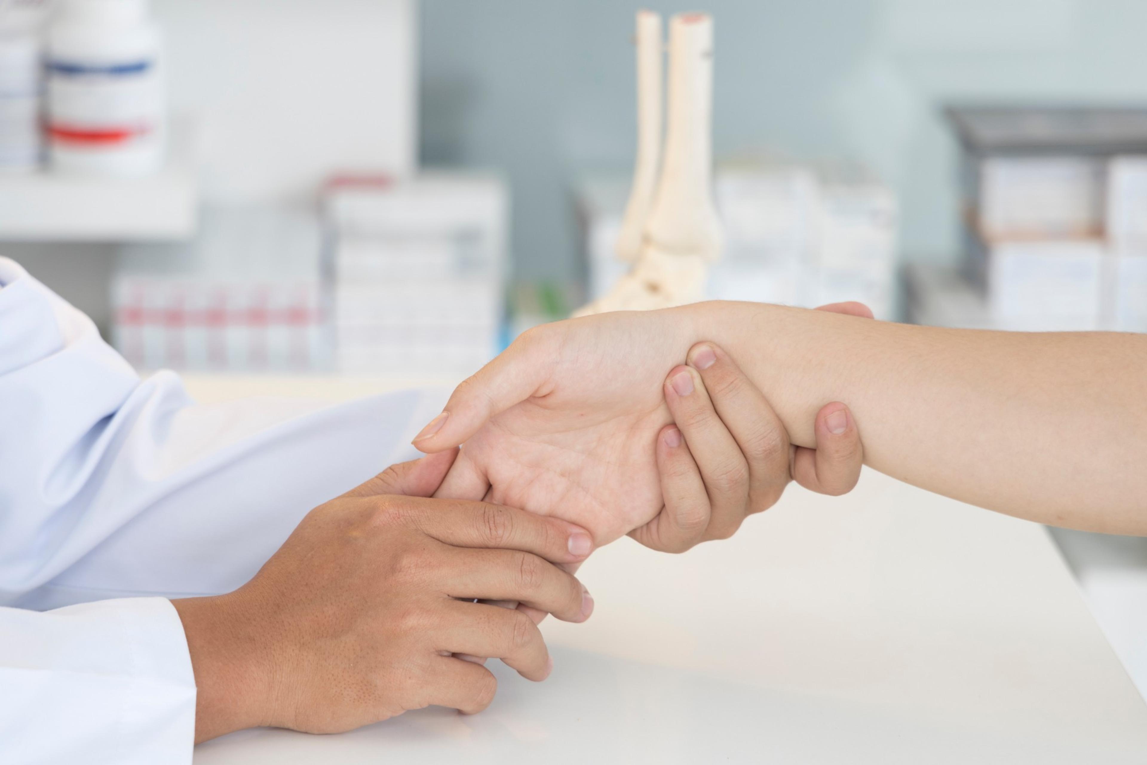 A doctor examining a patient's wrist