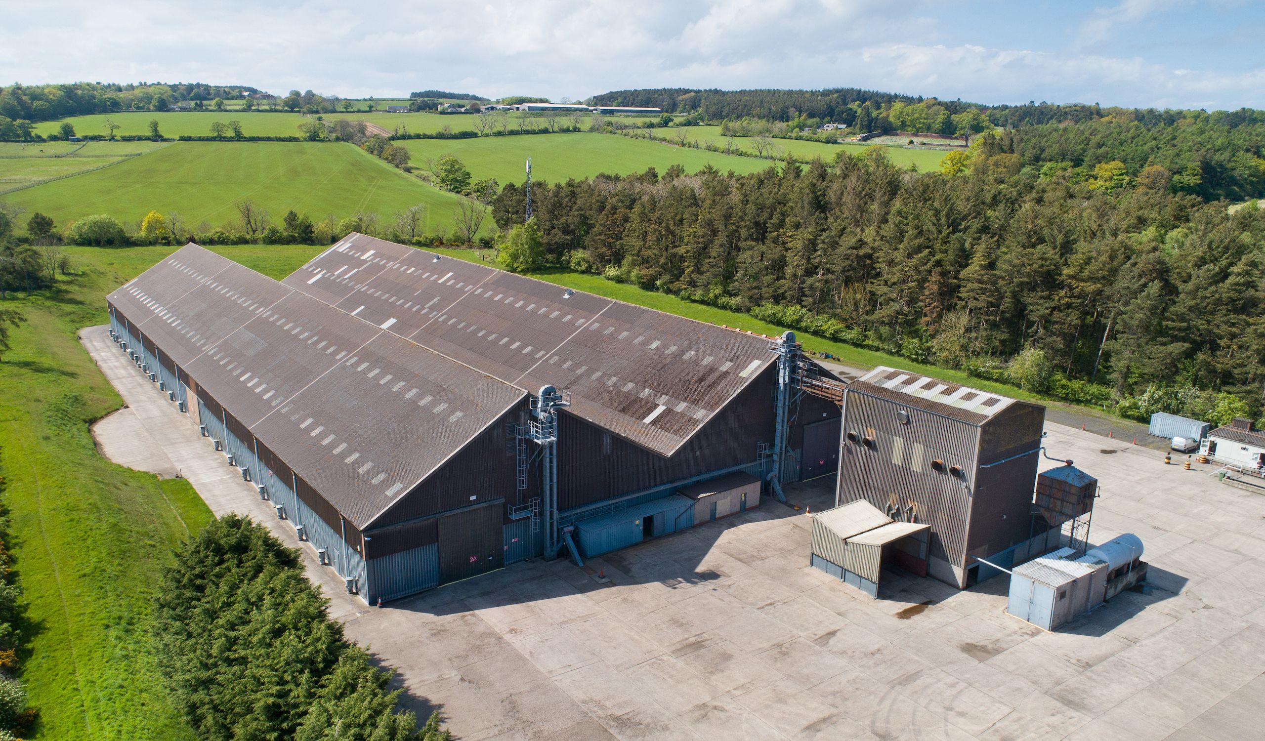 Aerial photo of North East Grains storage facility, with large grains sheds and grain drying equipment