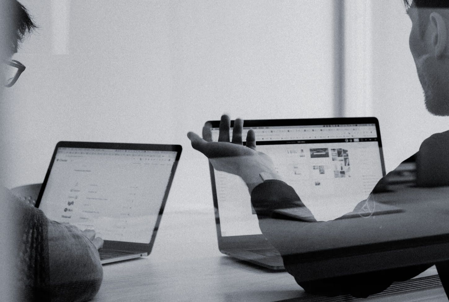 Two people in front of their computers