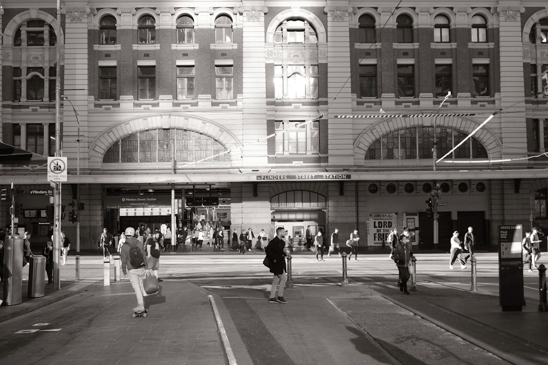 People crossing street in front of grand building