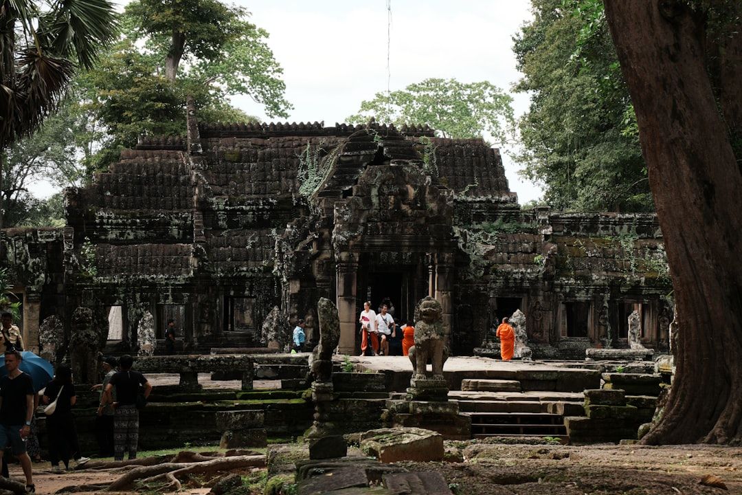 Ancient stone temple ruins surrounded by lush green trees.