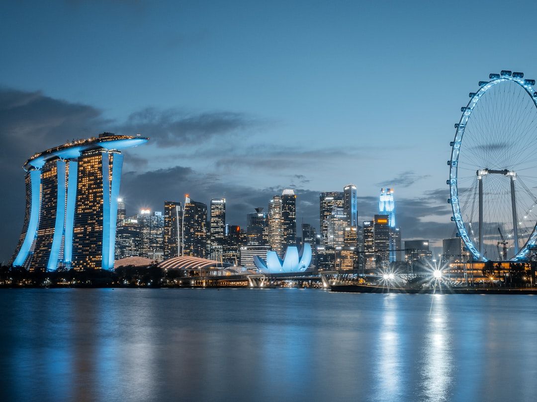 Singapore skyline with marina bay sands and ferris wheel.
