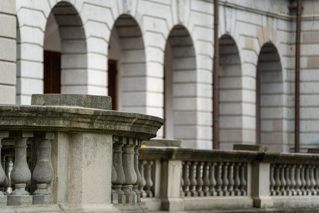 Stone balustrade and arched walkway of building