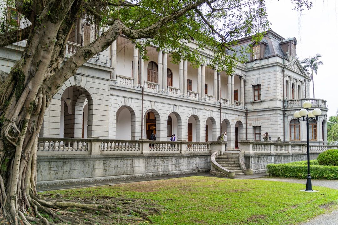 Grand building with large tree in foreground