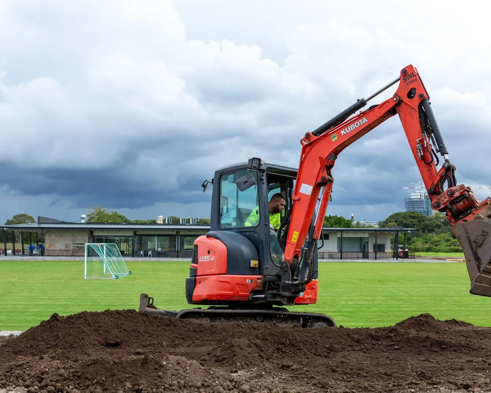 An excavator working across an open field
