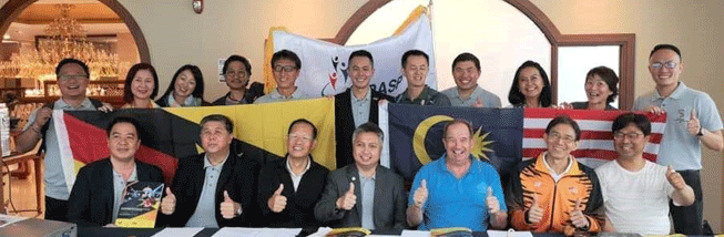 Image of SNOWDAN (SEATED CENTRE) WITH THE MALAYSIAN DELEGATION DURING THE BIDDING OF ASPASP