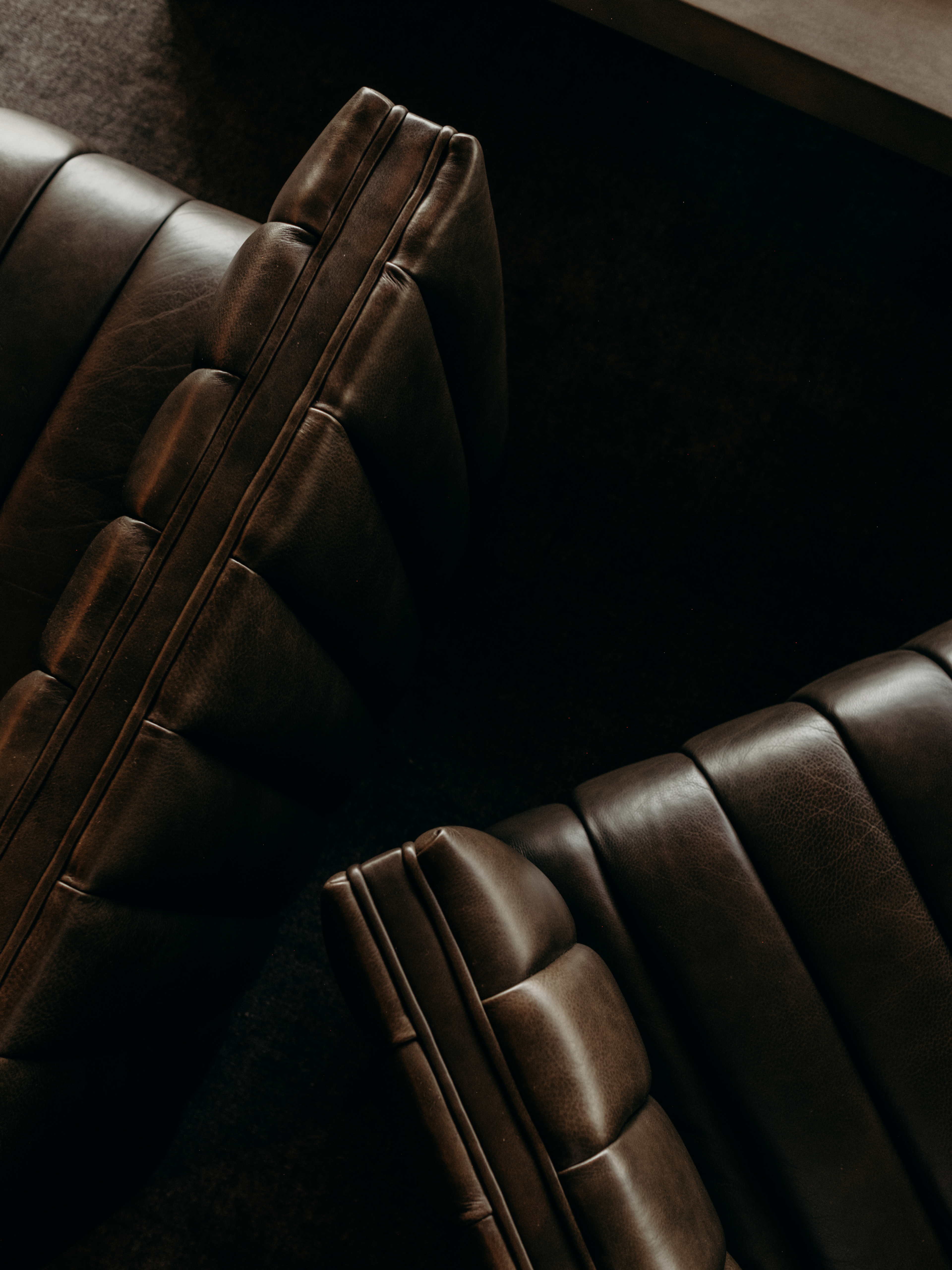 Bird's eye view of two brown leather chairs