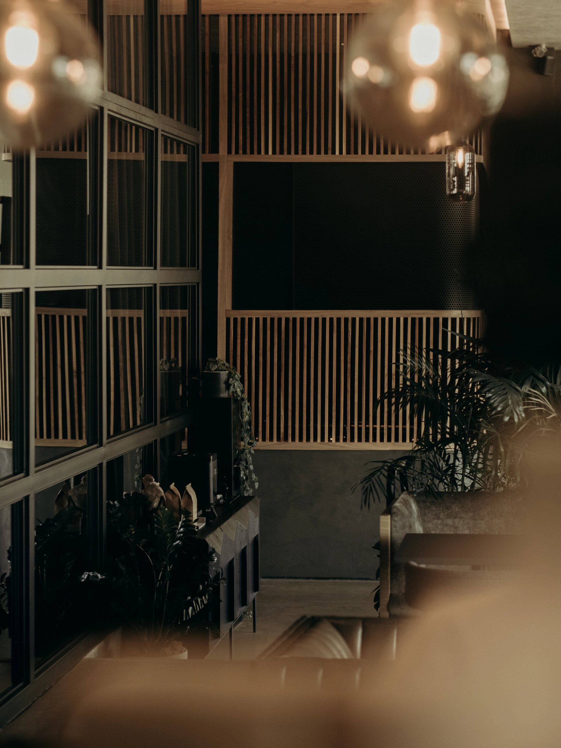 Light bulbs floating in front of wood panels and Venetian plaster