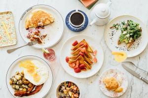 Plates of brunch food on marble table