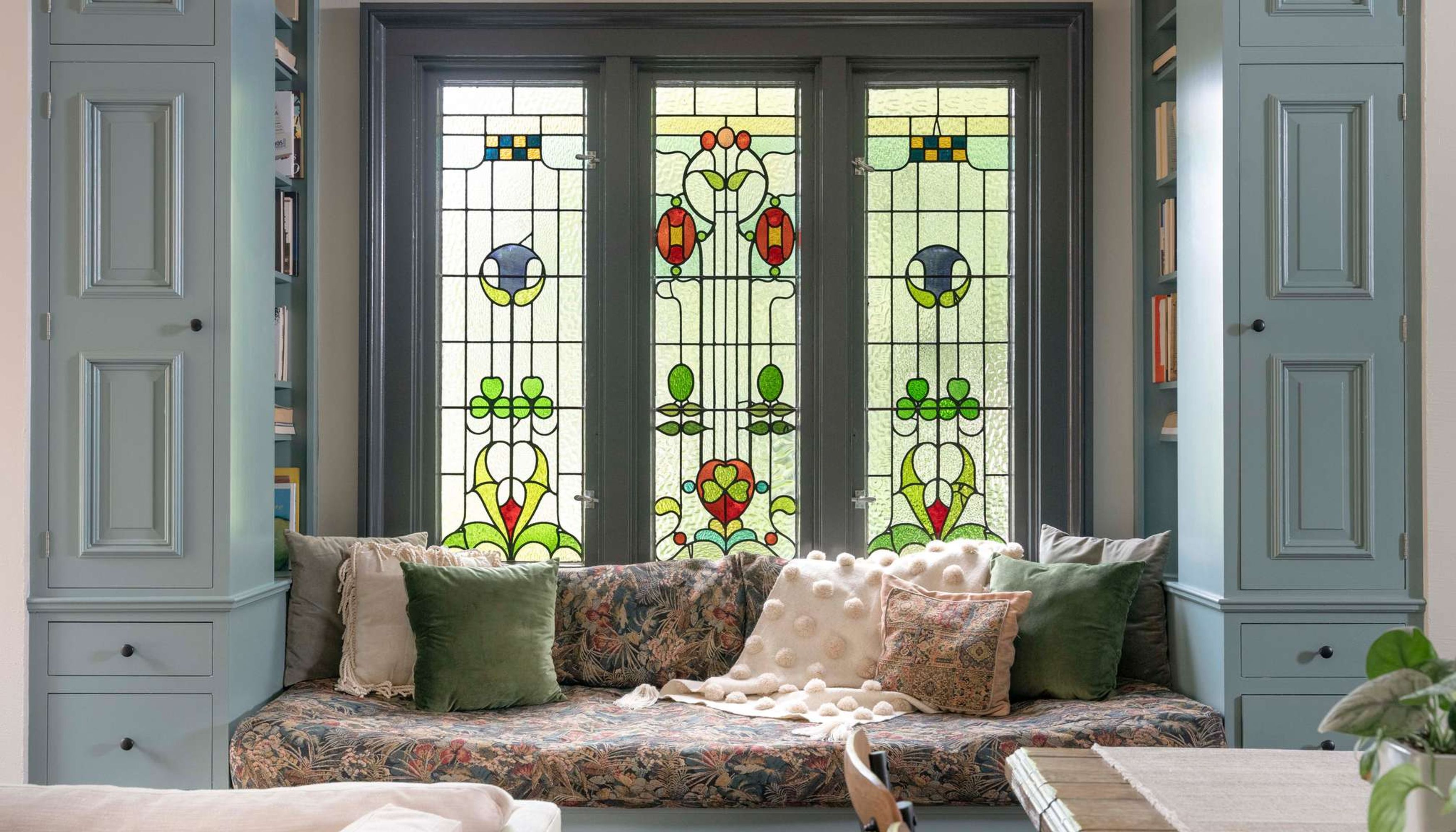 Window seat with stain glass windows and bookcasesundefined
