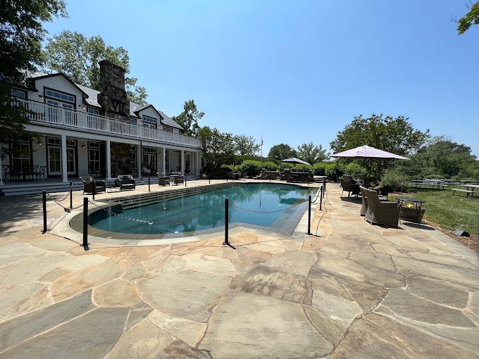 pool surrounded by a stonework and a white buildingundefined