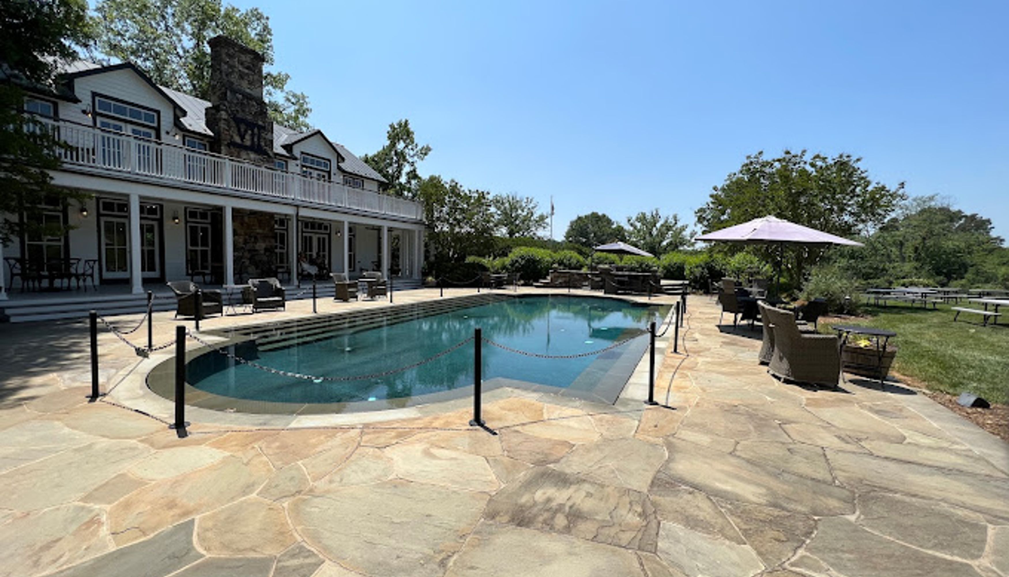 pool surrounded by a stonework and a white buildingundefined