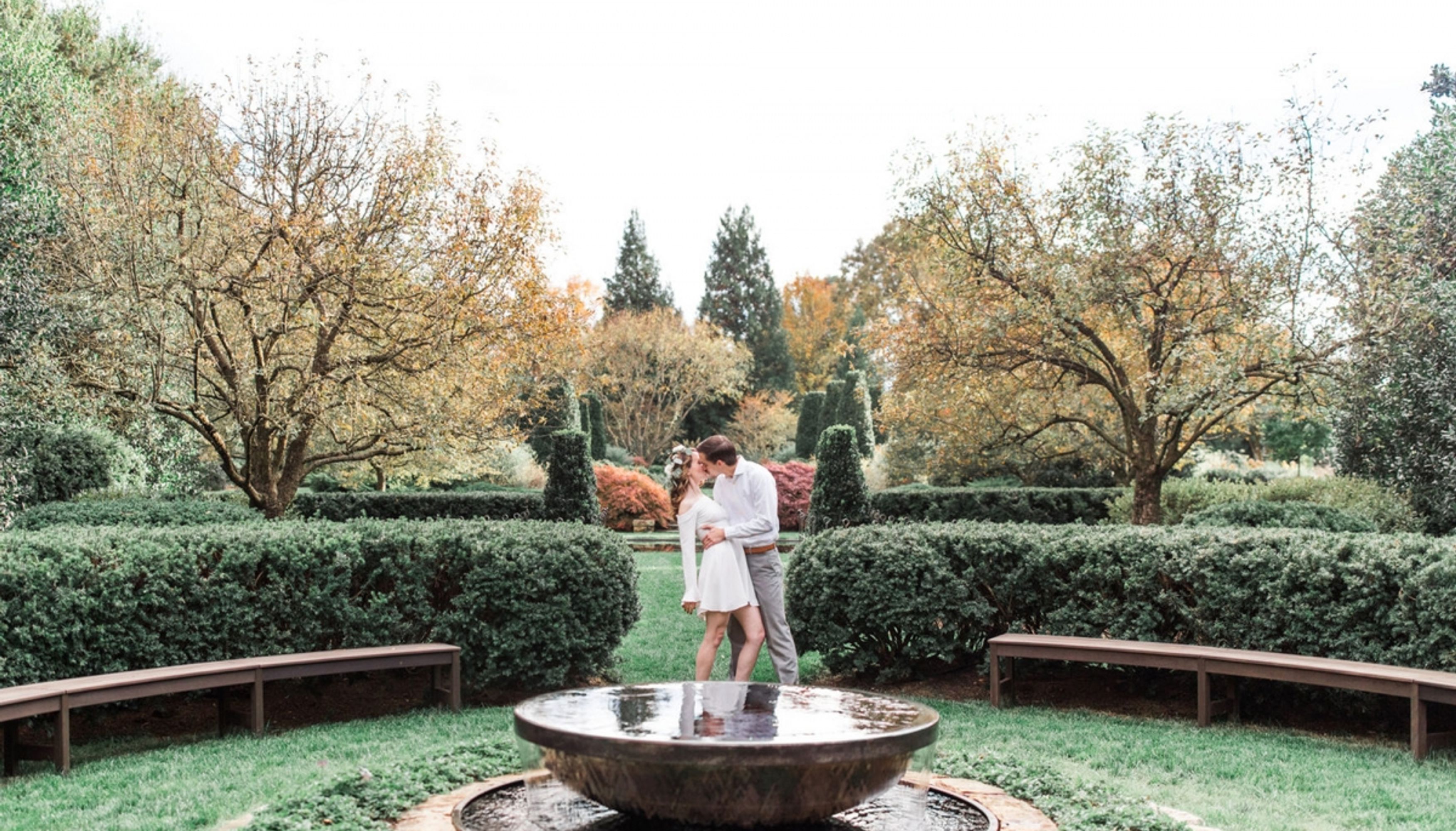 man and woman kissing in gardenundefined