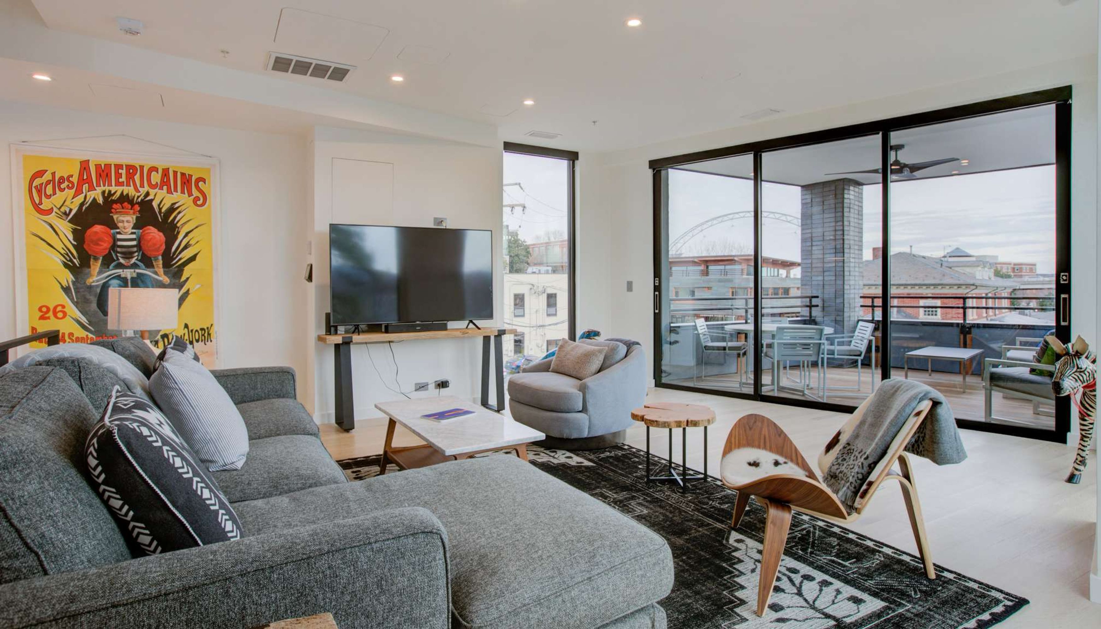 Grey couch in living room with view of charlottesville downtownundefined