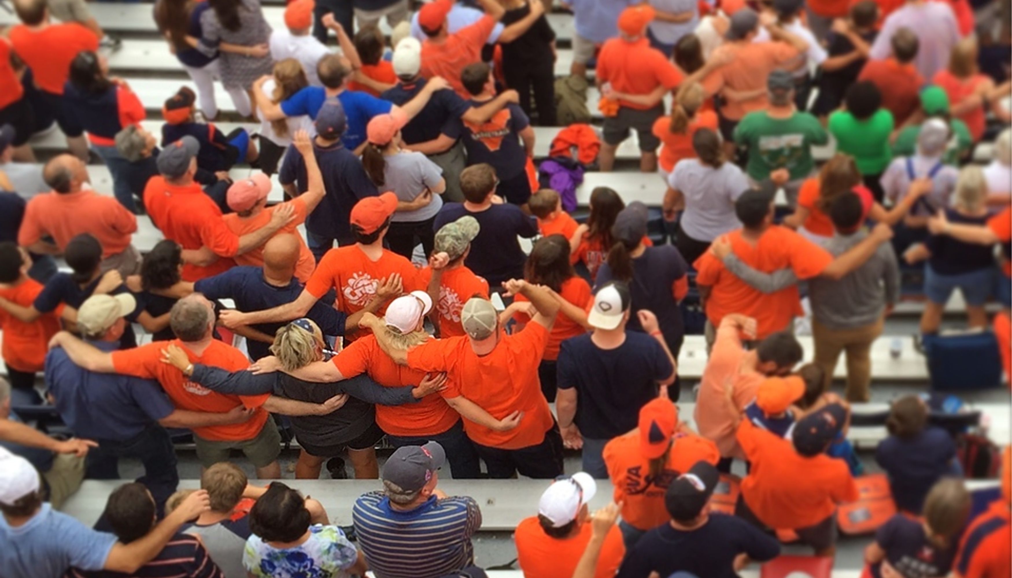 Students wearing navy blue and orange in UVA football standsundefined