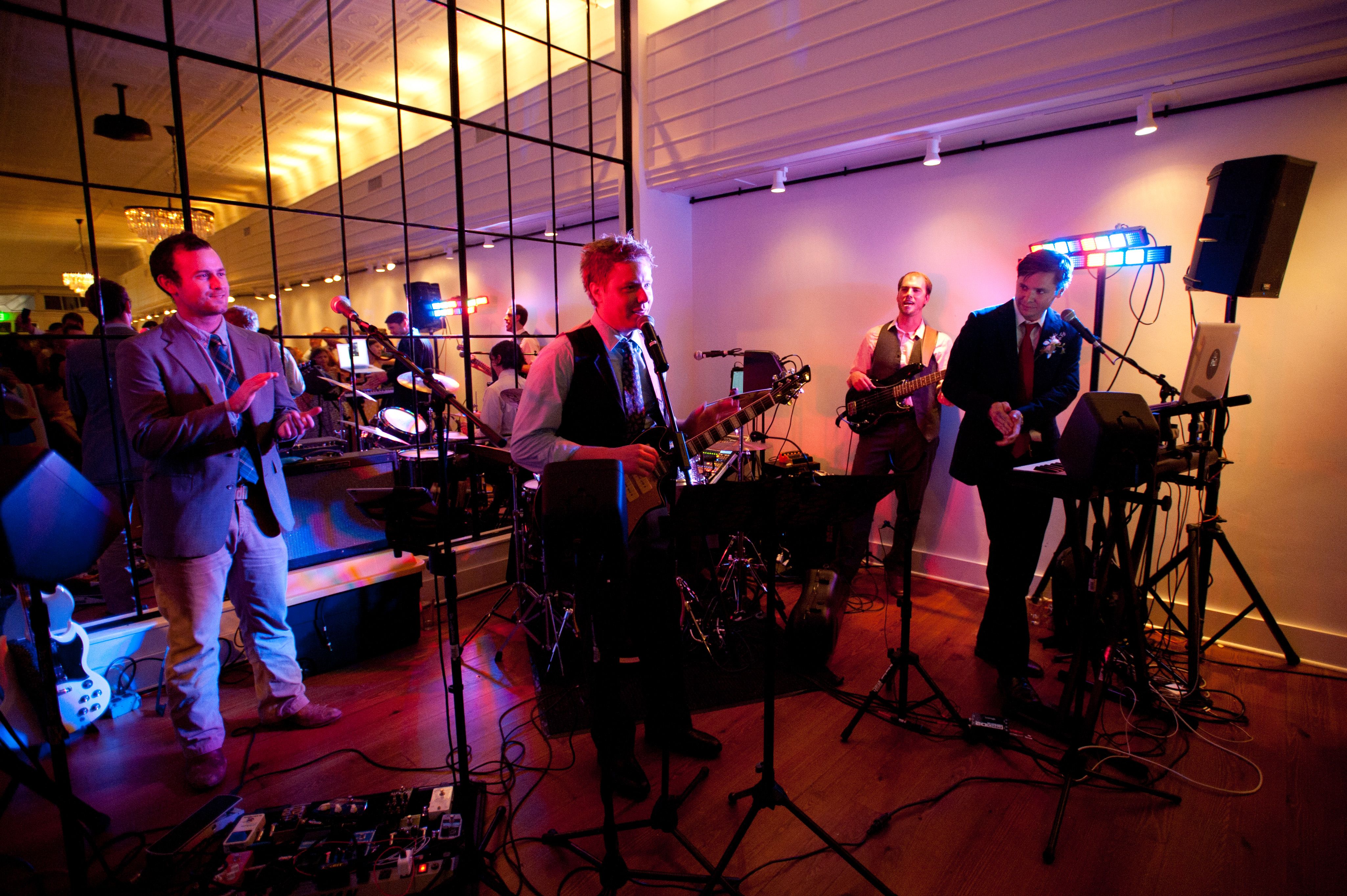 Wedding band playing in front of mirrored wall
