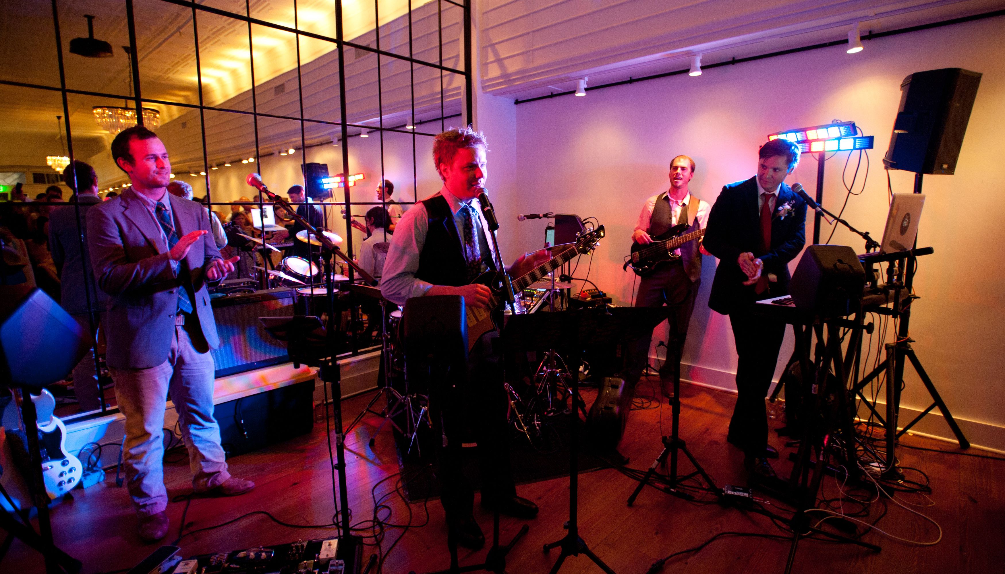 Wedding band playing in front of mirrored wall