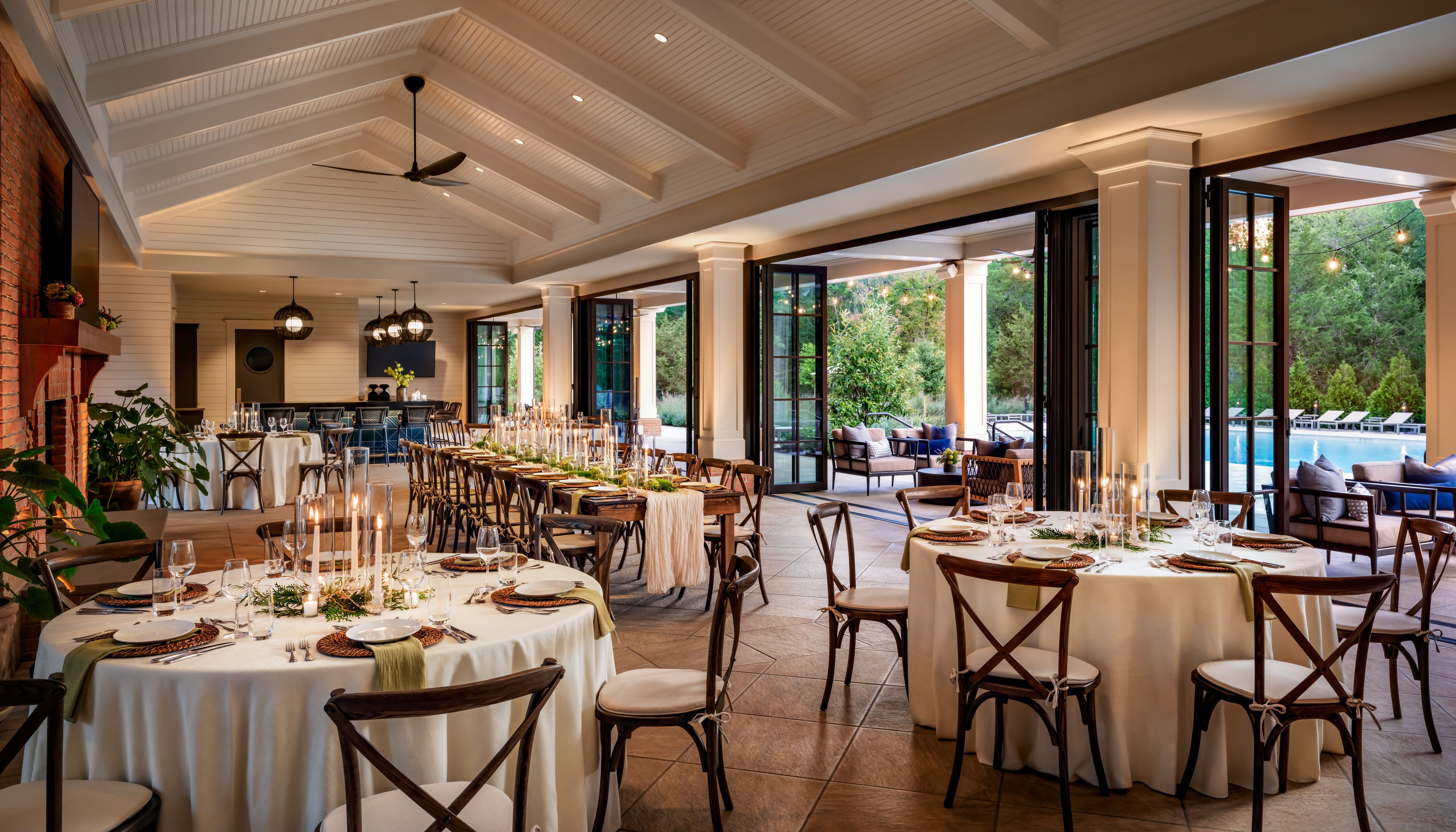 event space with tables covered in white table clothes and wooden chairsundefined