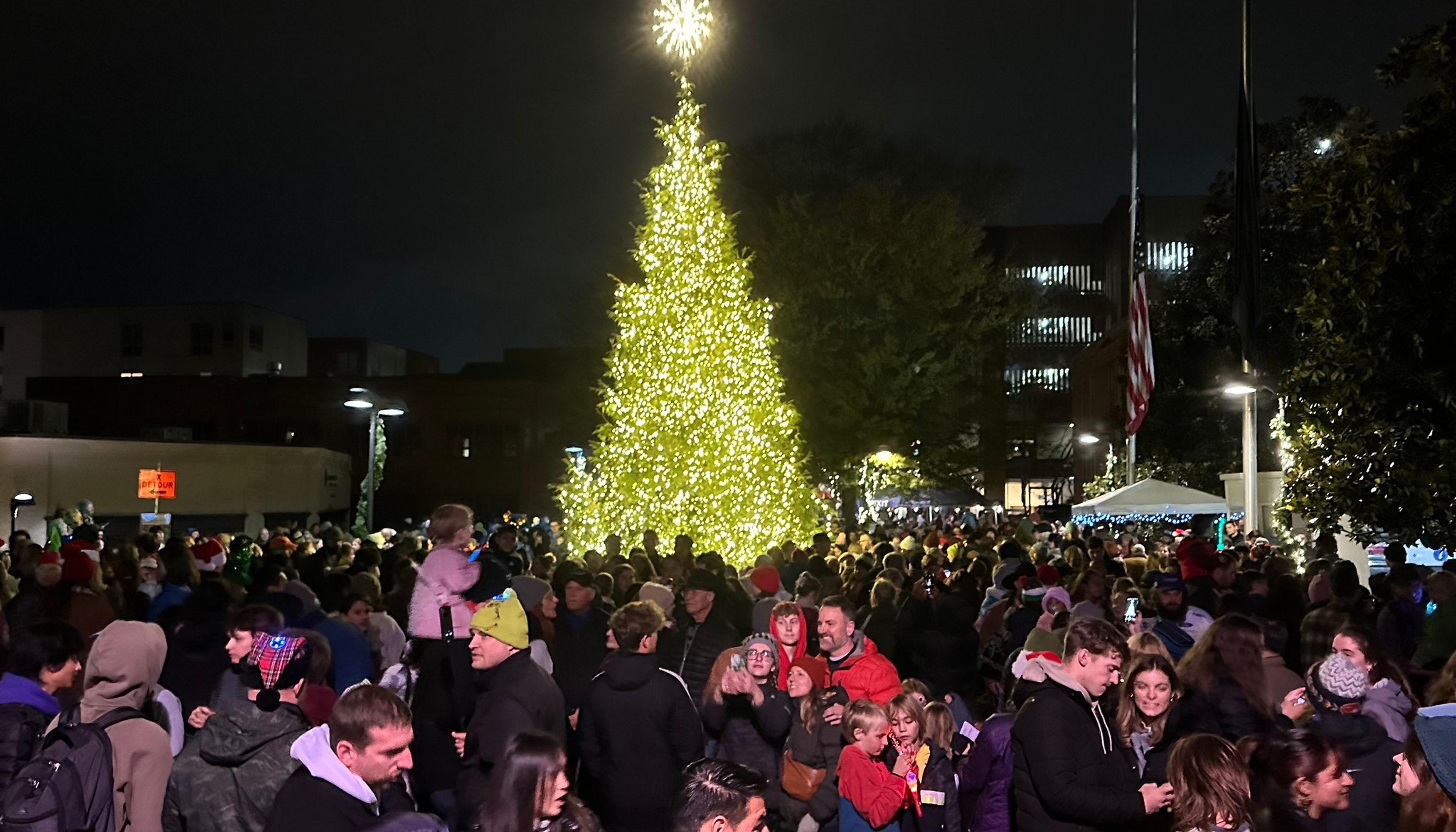 Crowd in front of large lit up Christmas treeundefined