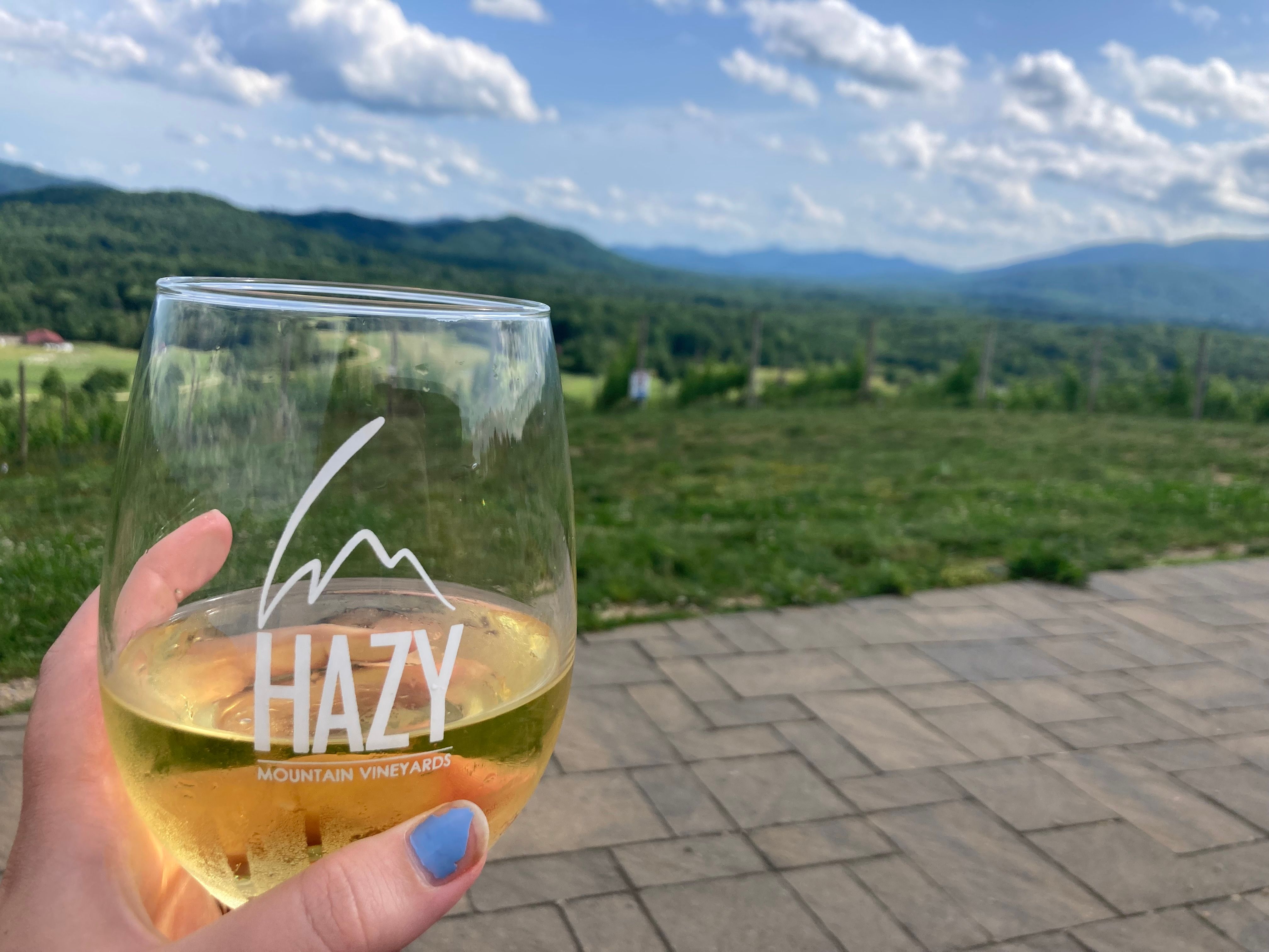 wine glass with hazy mountain label in front of mountain viewundefined
