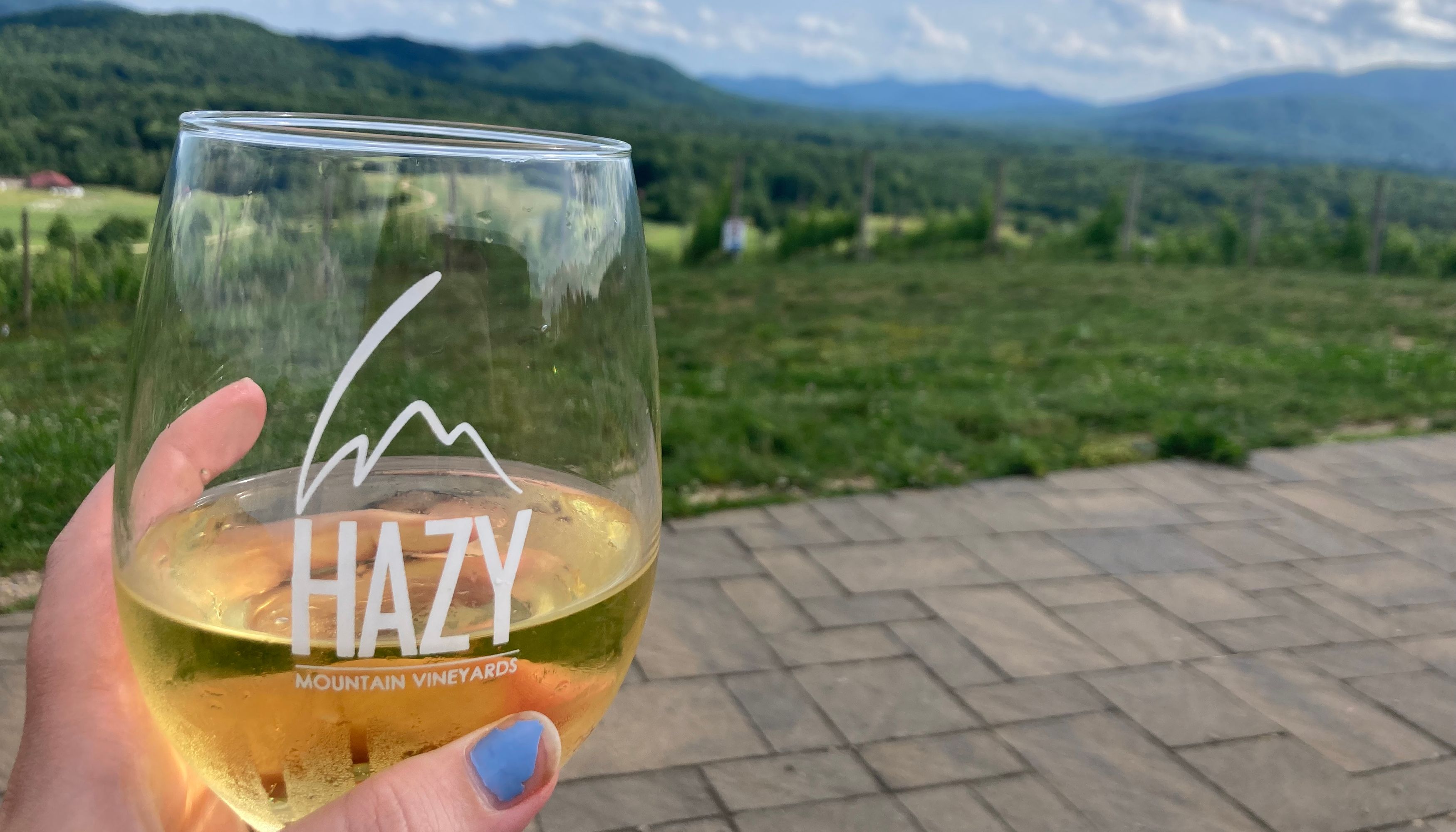 wine glass with hazy mountain label in front of mountain viewundefined