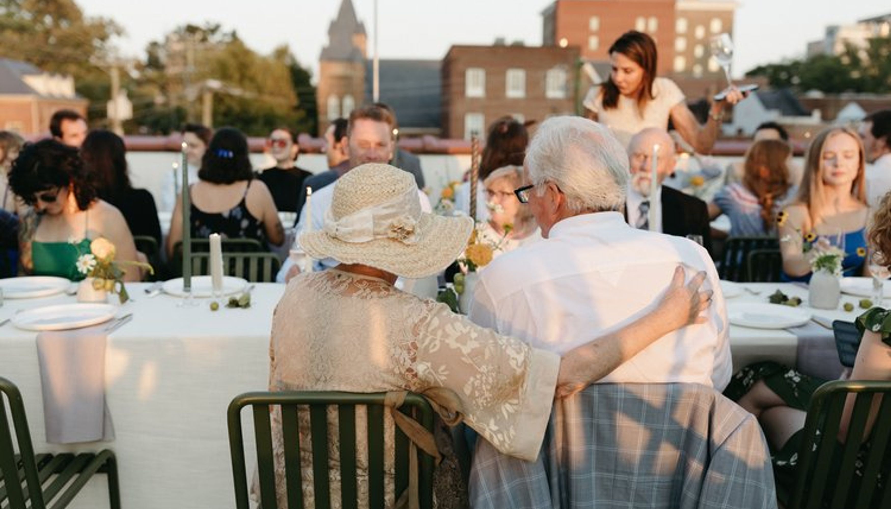 man and woman at a table on a rooftopundefined
