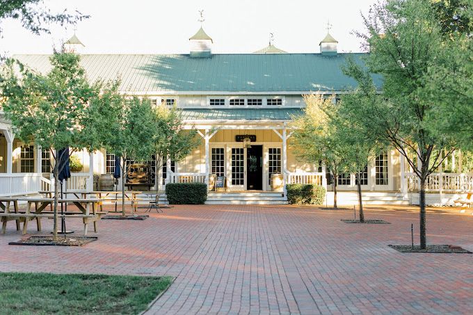 brick patio in front of white building with green roofundefined