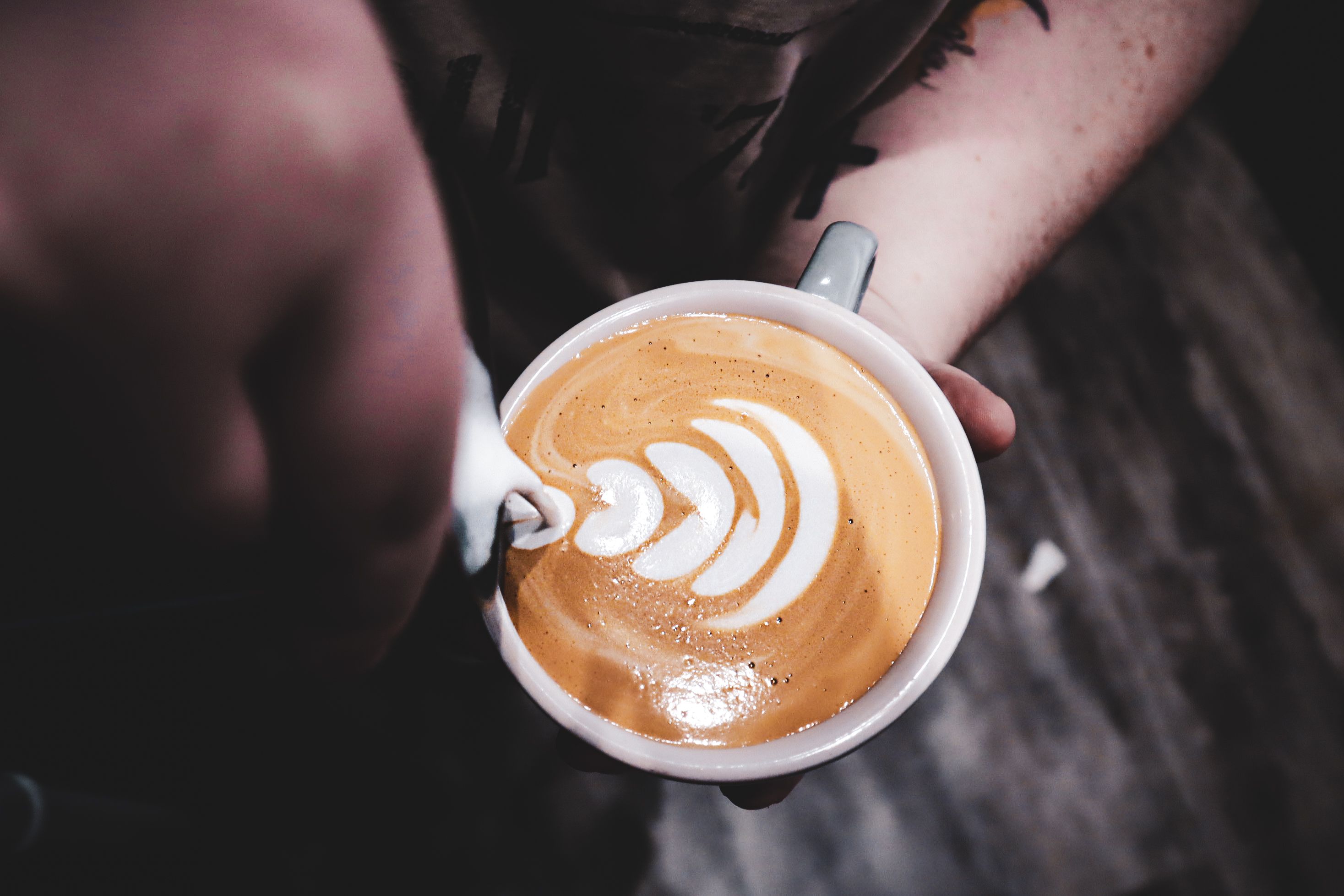 Barista creating flower latte art