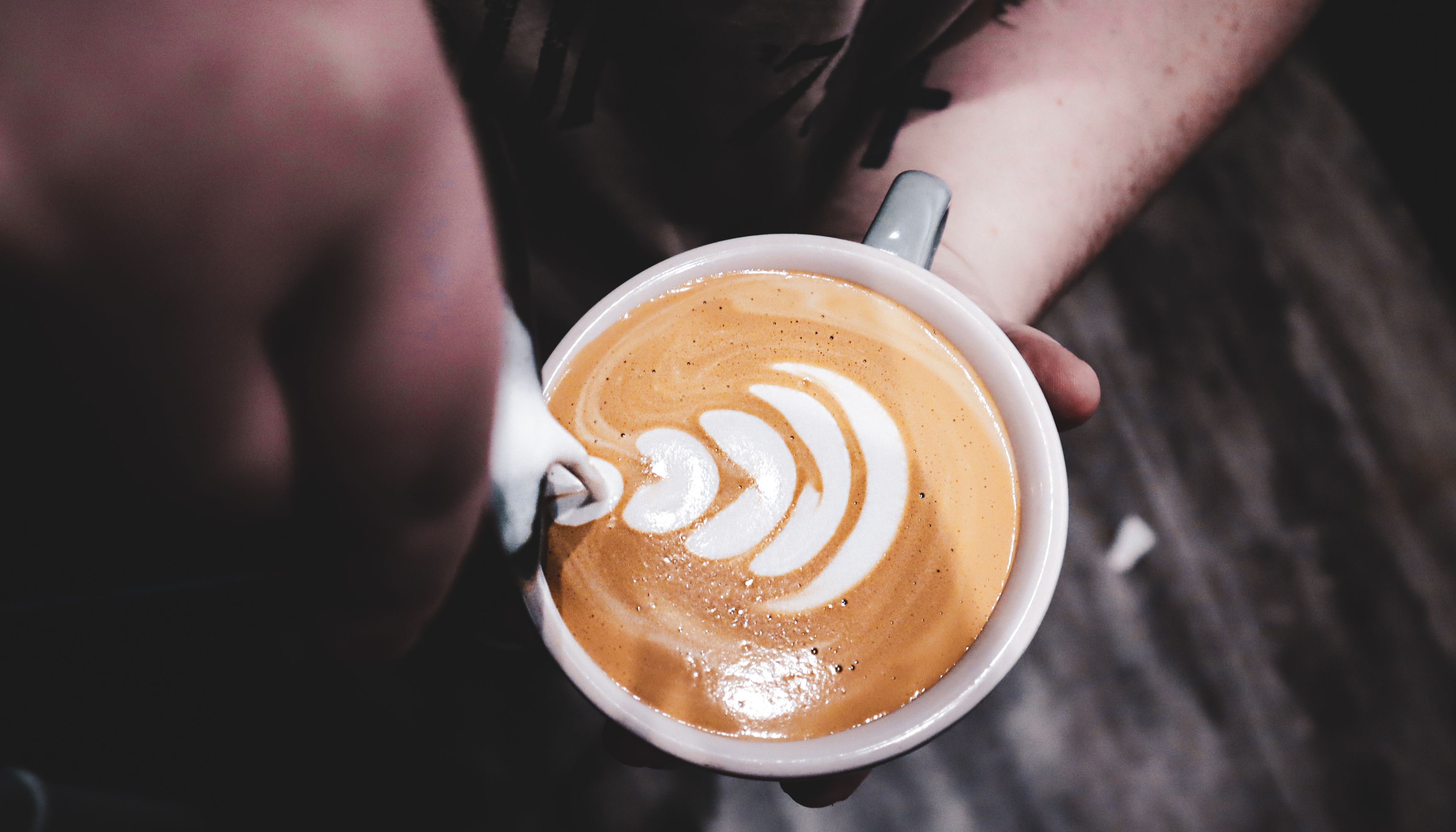 Barista creating flower latte art
