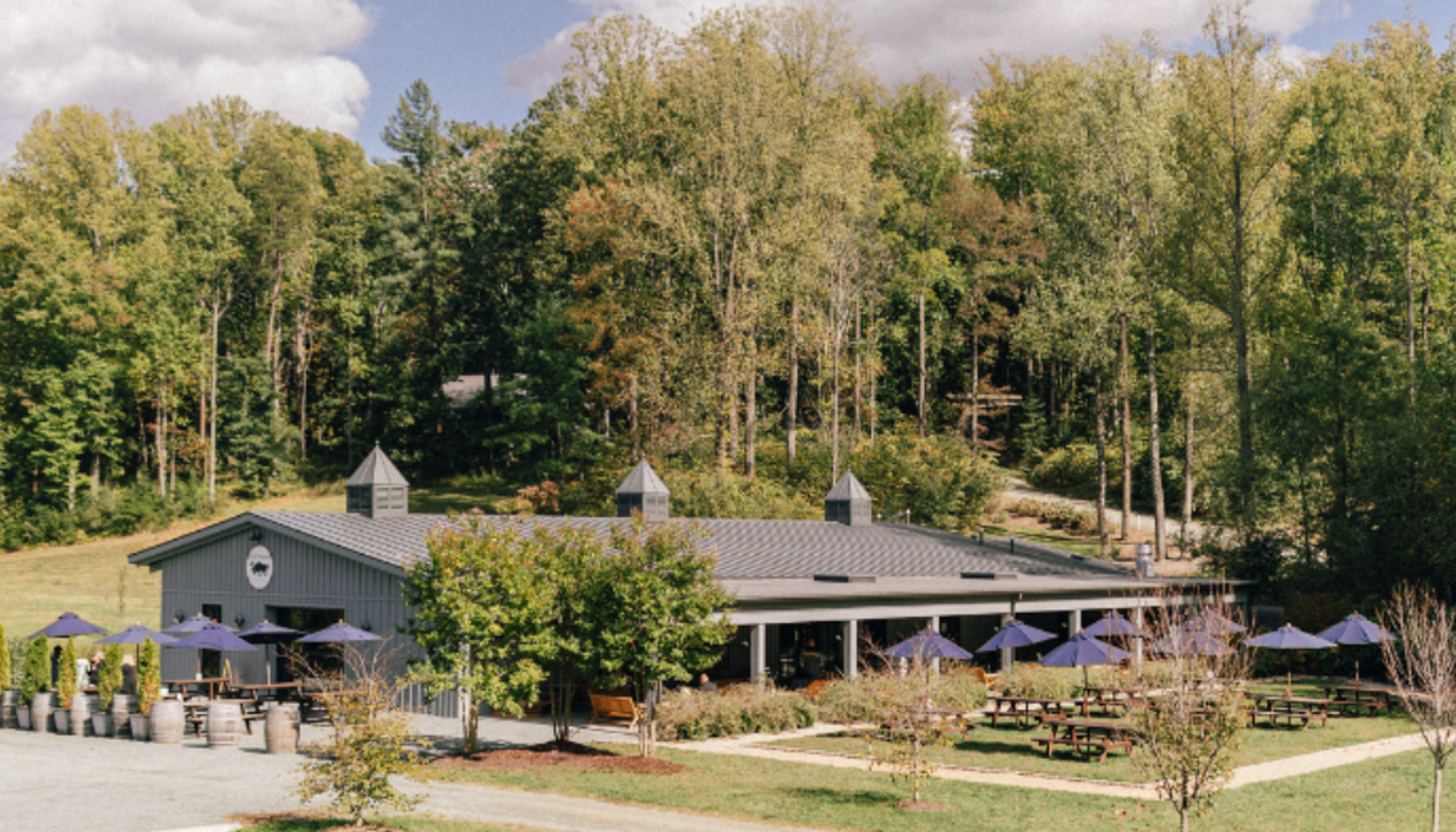 Grey Building with tables with blue umbrellasundefined