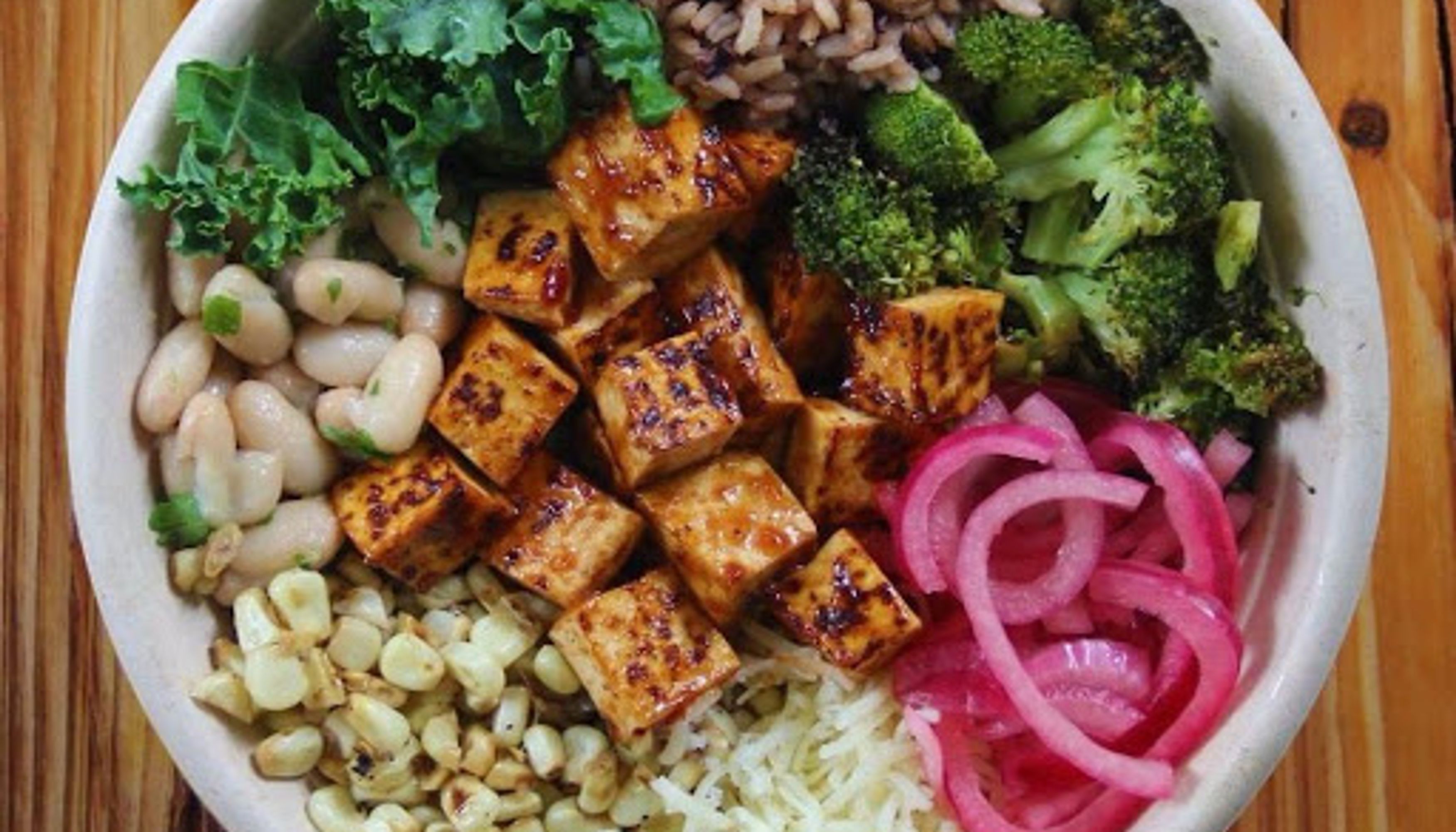 grain bowl with chicken, broccoli, rice and pickled onionsundefined