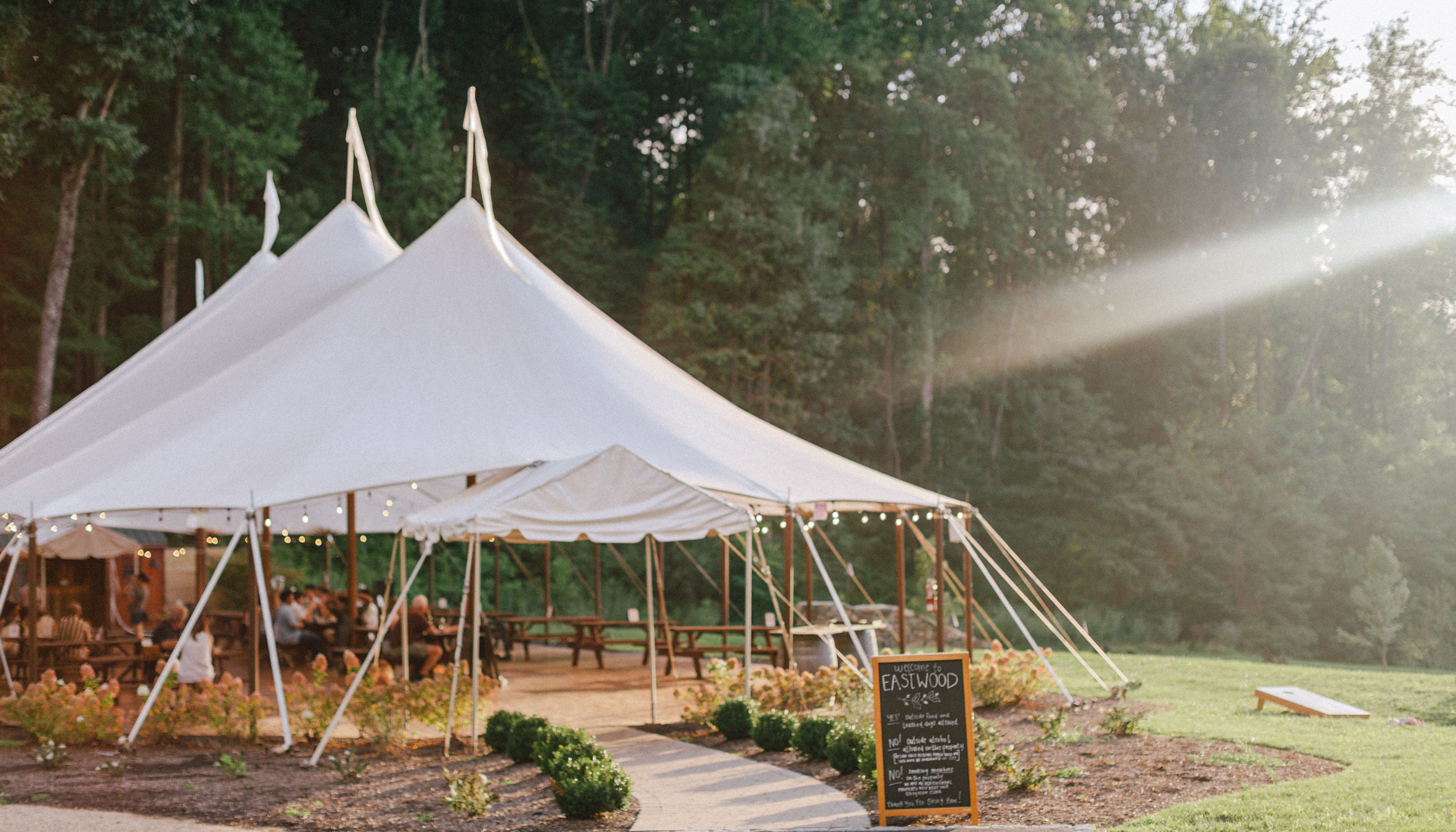 Large white tent with tables underneath