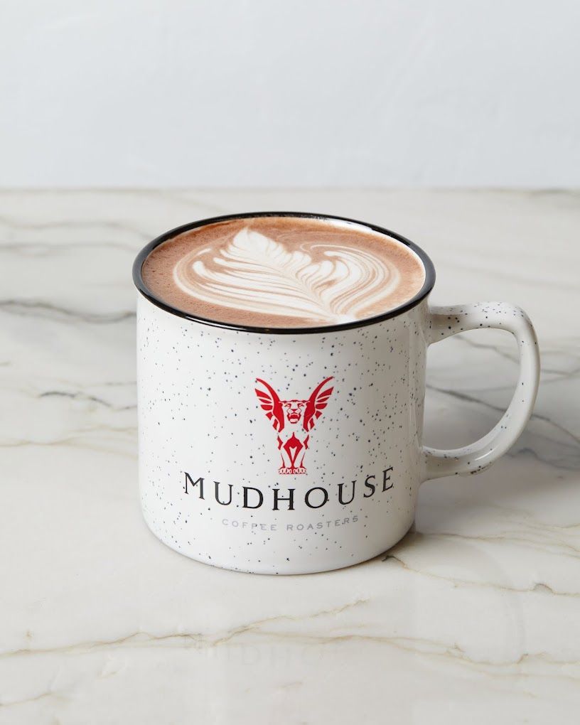 Latte in a mudhouse coffee cupundefined