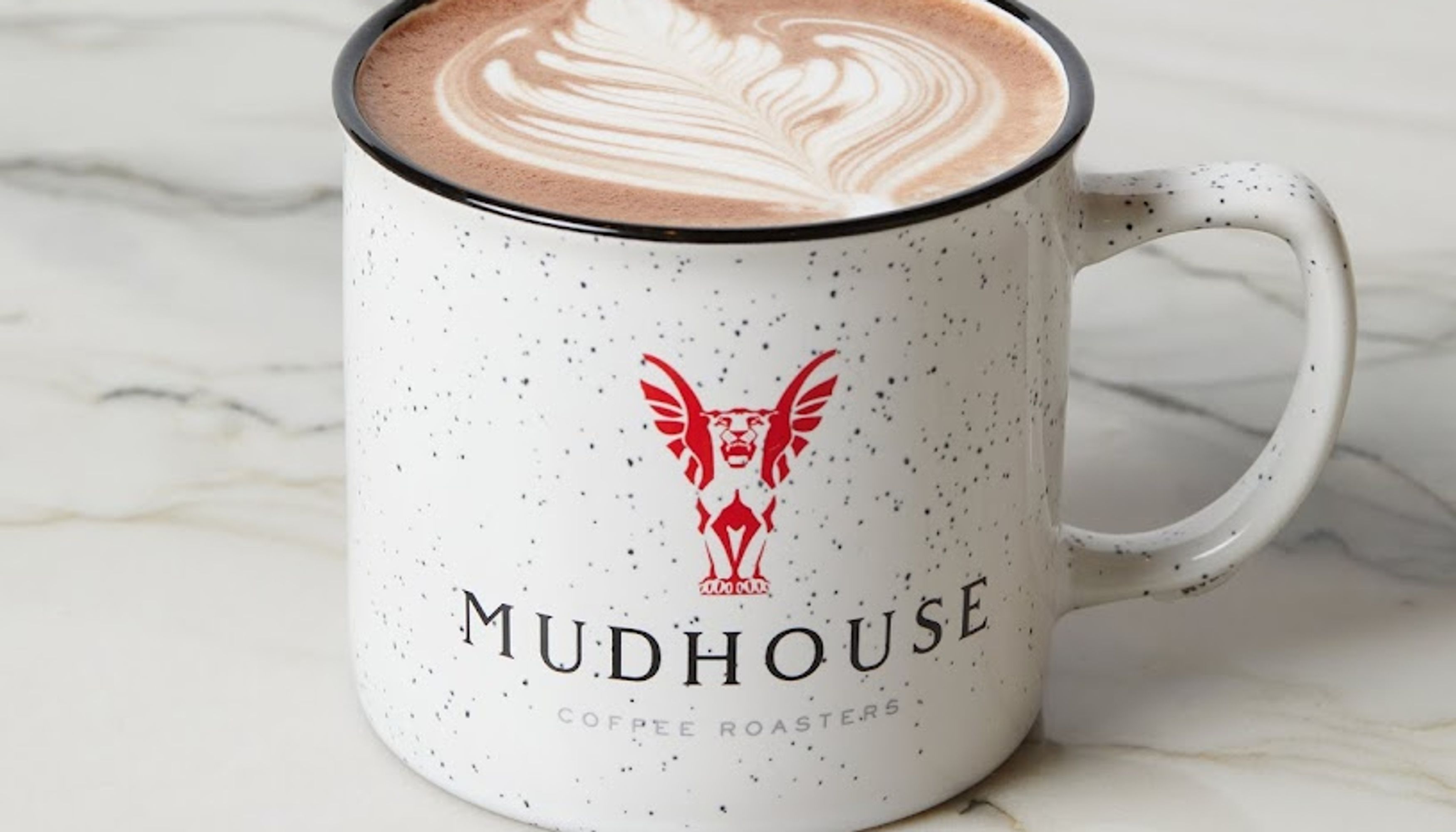 Latte in a mudhouse coffee cupundefined