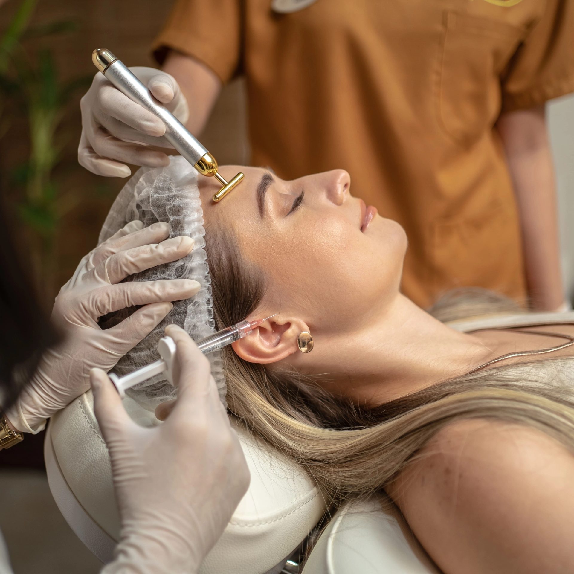 A woman receiving a skin booster treatment on the forehead