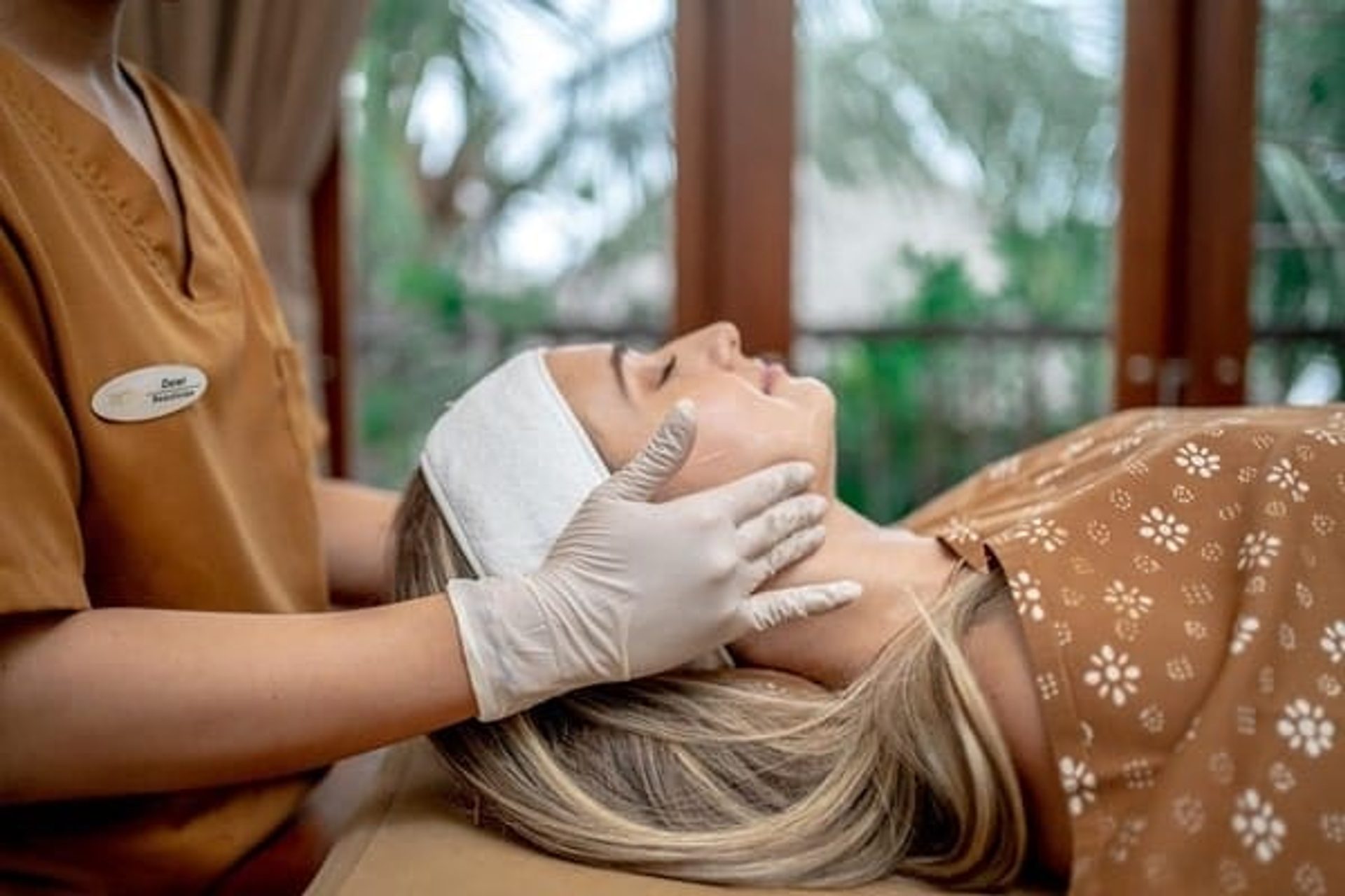 Therapist preparing a client for a facial at Healthy Look Aesthetic