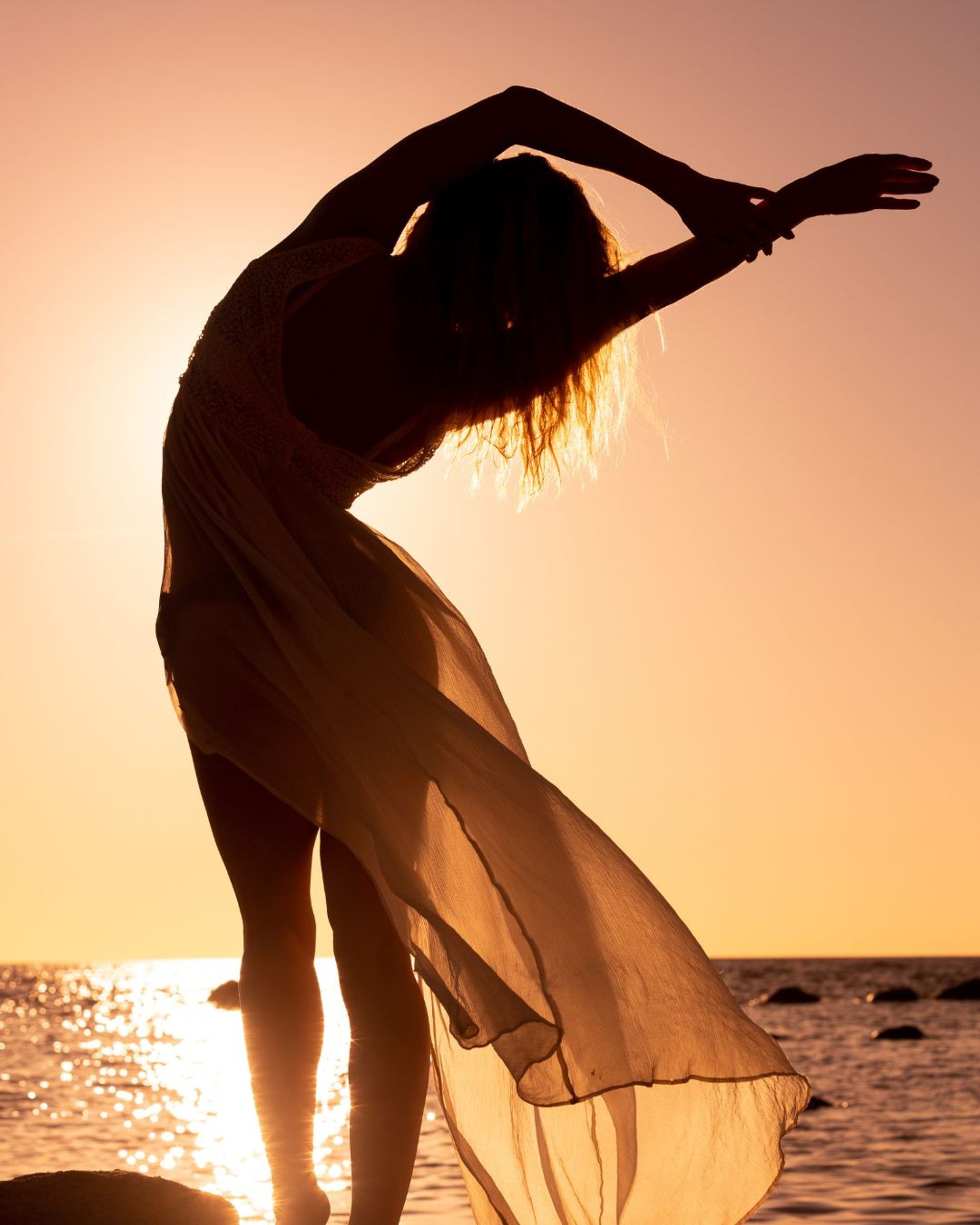 Silhouette of a woman at sunset