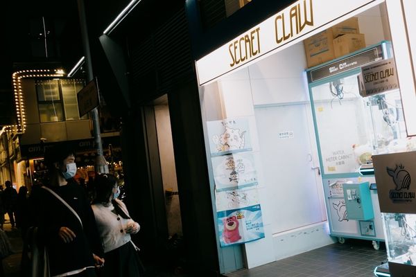 A group of people standing outside of a store