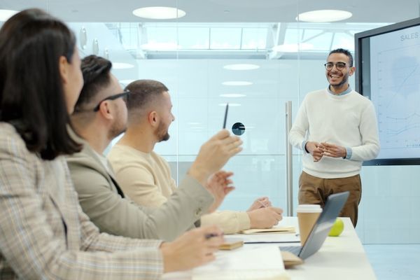 Man presenting to colleagues in a modern office setting