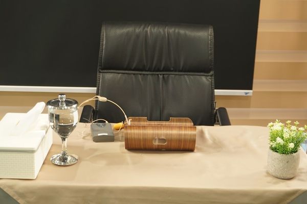 clear wine glass beside brown wicker basket on table
