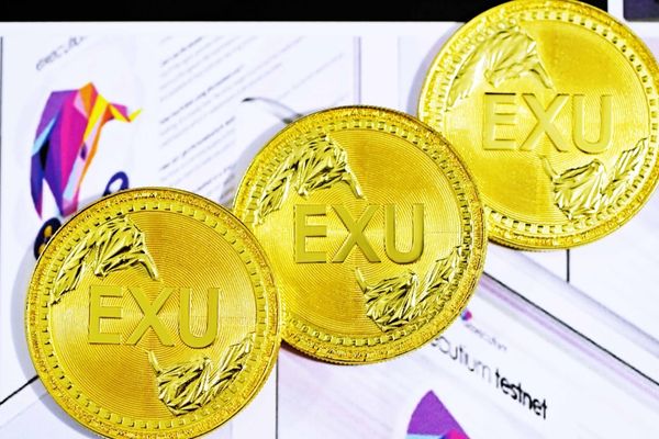 gold round coin on white paper