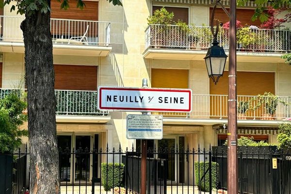 A street sign in front of a tall building