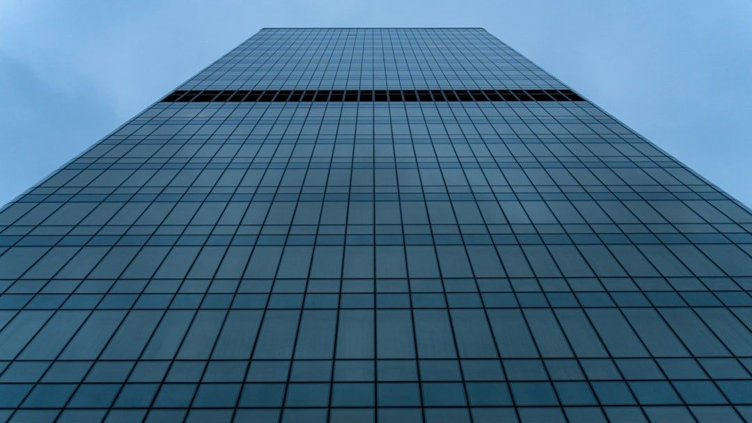 A tall glass skyscraper reaches into the sky.